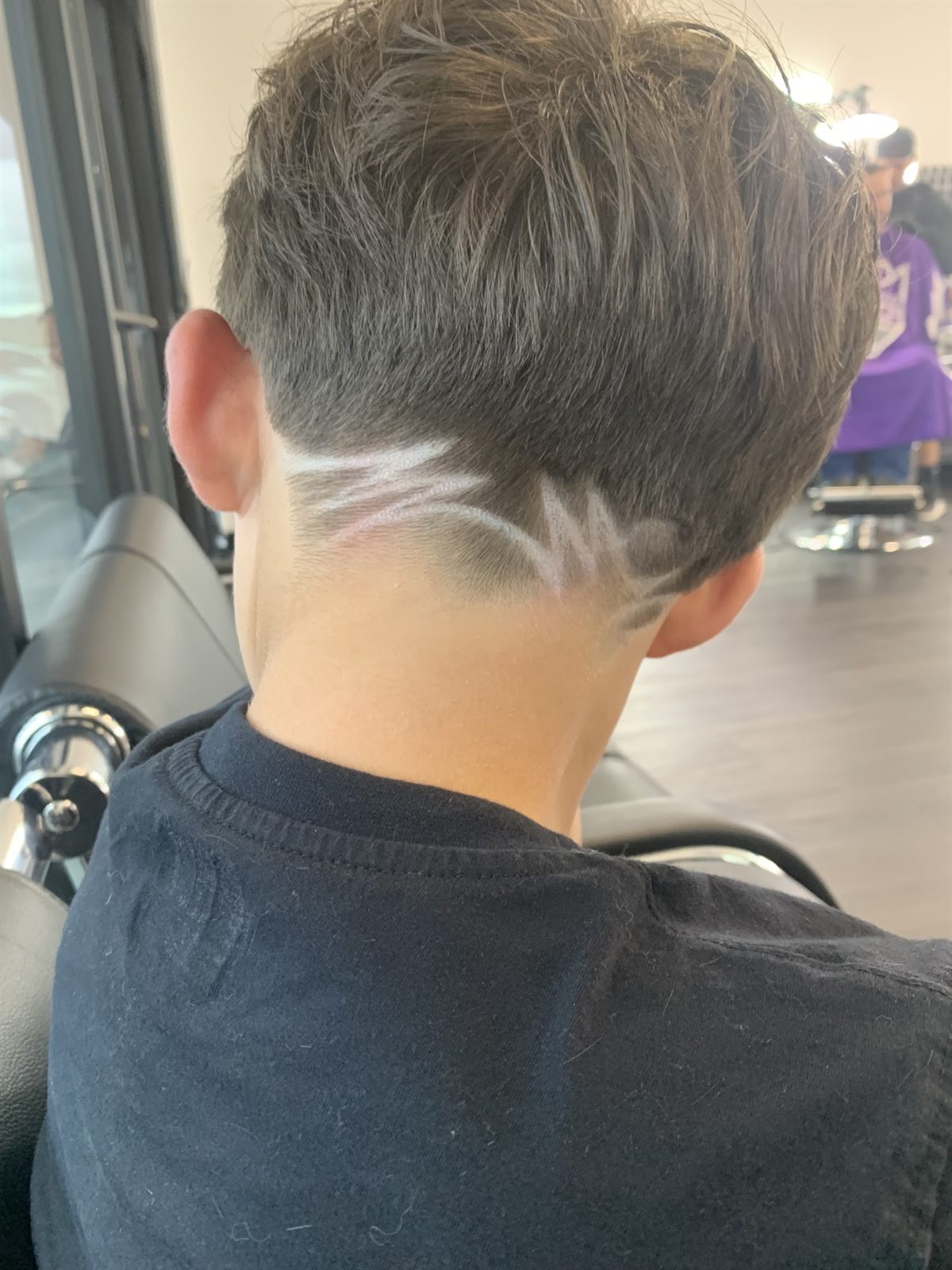 A finished hair design cut freehand into the back of a client's fade at Faded Rey's Barbershop